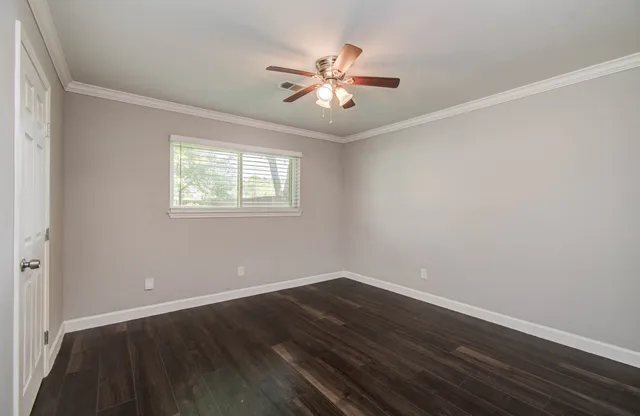 a view of a room with wooden floor and windows