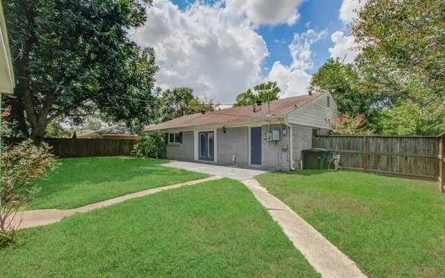 a front view of a house with a yard and trees