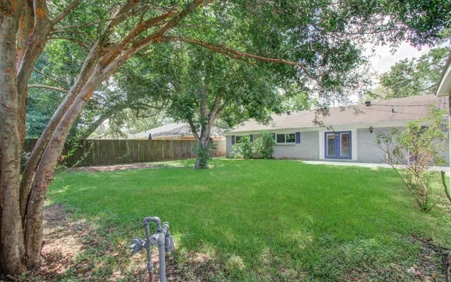 a front view of house with yard and green space