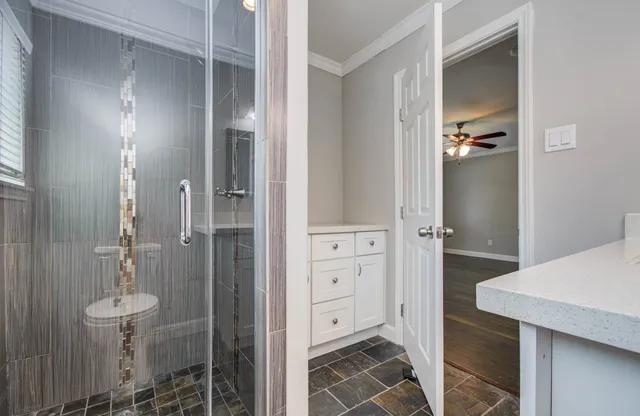 a bathroom with a shower and a sink