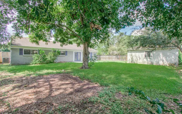 a view of a house with a yard and a garden