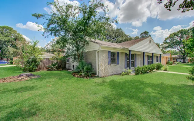 a front view of a house with garden
