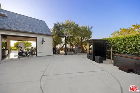 a hallway with lots of wooden furniture and entryway