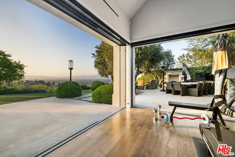 a living room with furniture and a large mirror