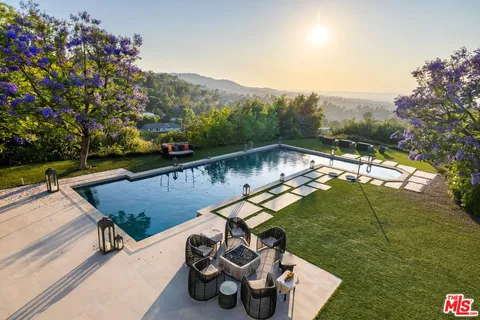a view of a house with pool outdoor seating area and fire pit