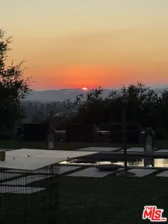 a view of a house with dining room and wooden fence