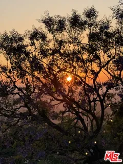 a view of a kitchen with kitchen island a stove a sink and dishwasher with couches