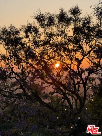 a view of a kitchen with kitchen island a stove a sink and dishwasher with couches
