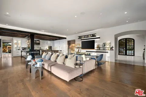 a kitchen with stainless steel appliances granite countertop a sink a stove and a wooden floors