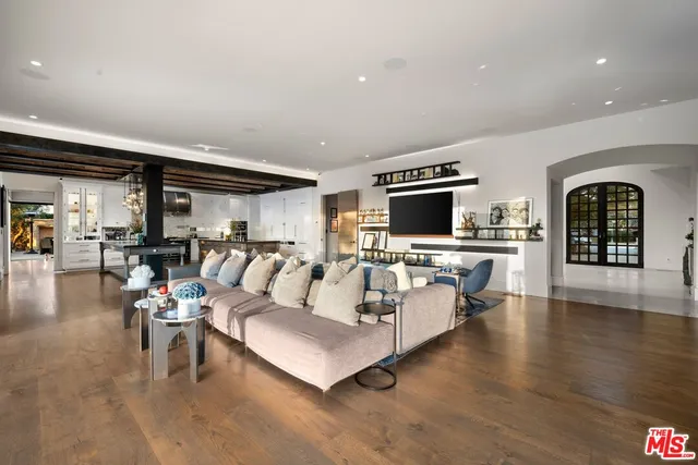 a kitchen with stainless steel appliances granite countertop a sink a stove and a wooden floors