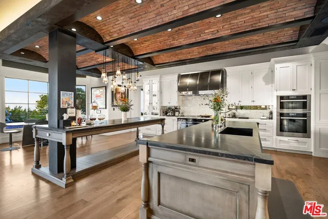a living room with furniture flat screen tv and a large window