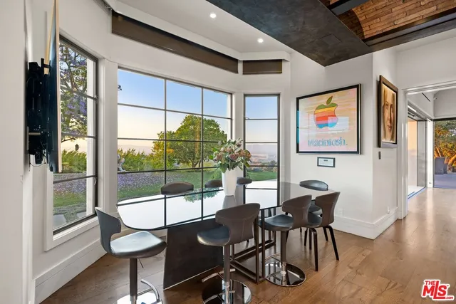 a living room with furniture and large windows