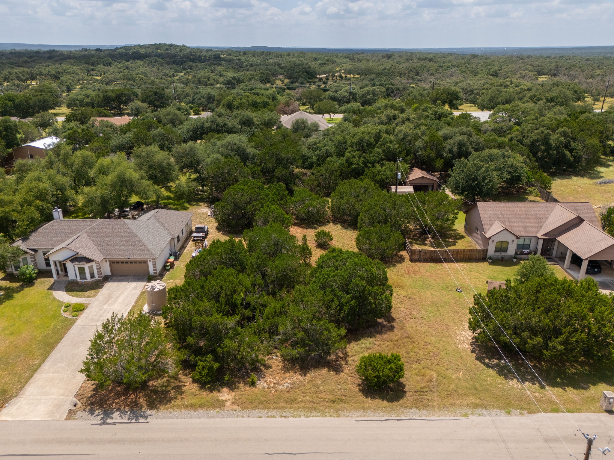 1170 Misty Lane Spring Branch, TX 78070 - Photo 2 of 24 An aerial perspective reveals the homes nestled within the expansive, verdant landscape of mature trees.