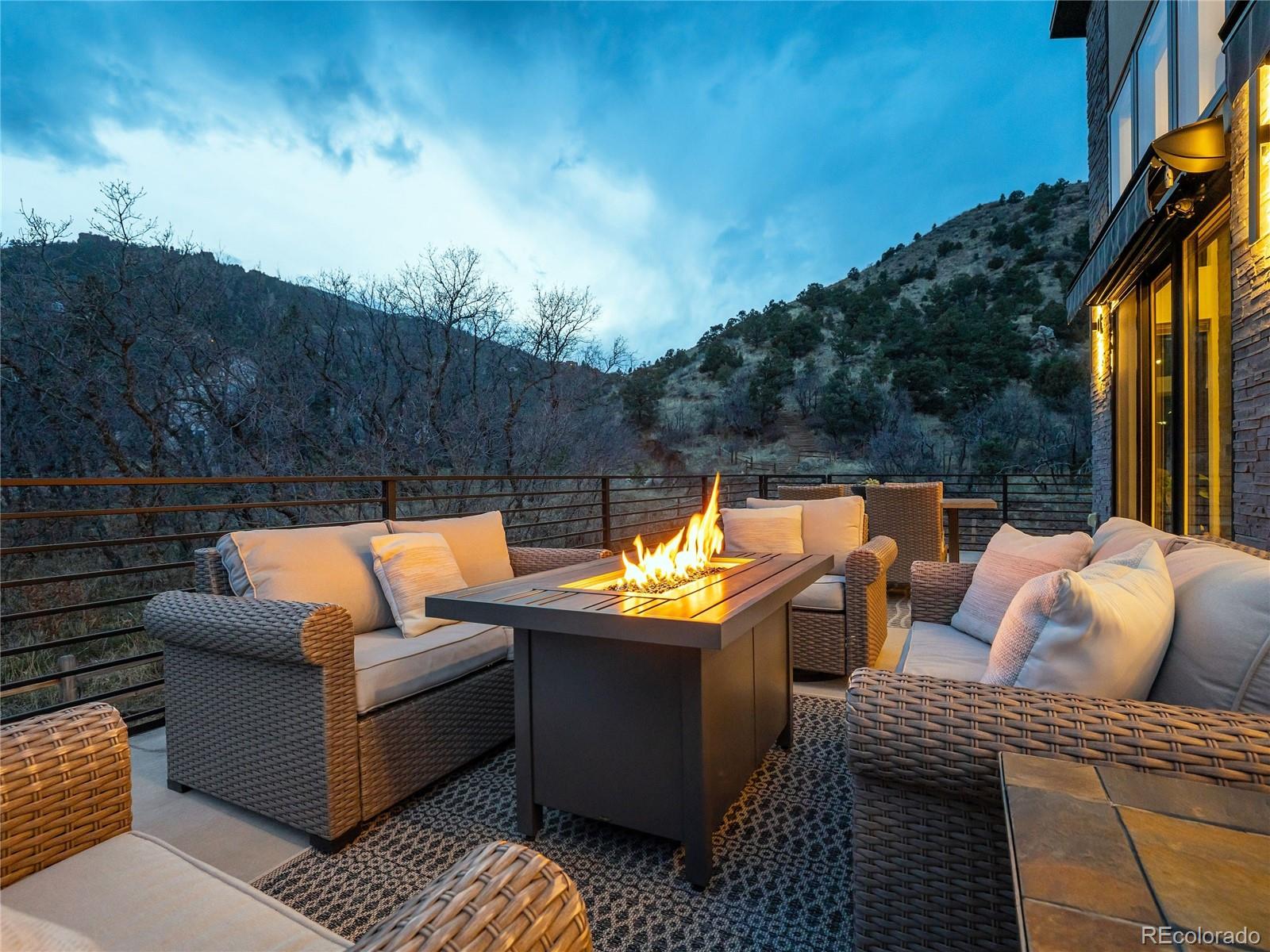 284 Crystal Park Road Manitou Springs, CO 80829 - Photo 2 of 39 a terrace of a house with couches and city view