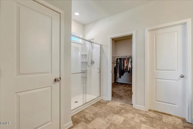 a spacious bedroom with a bed a couch and a window