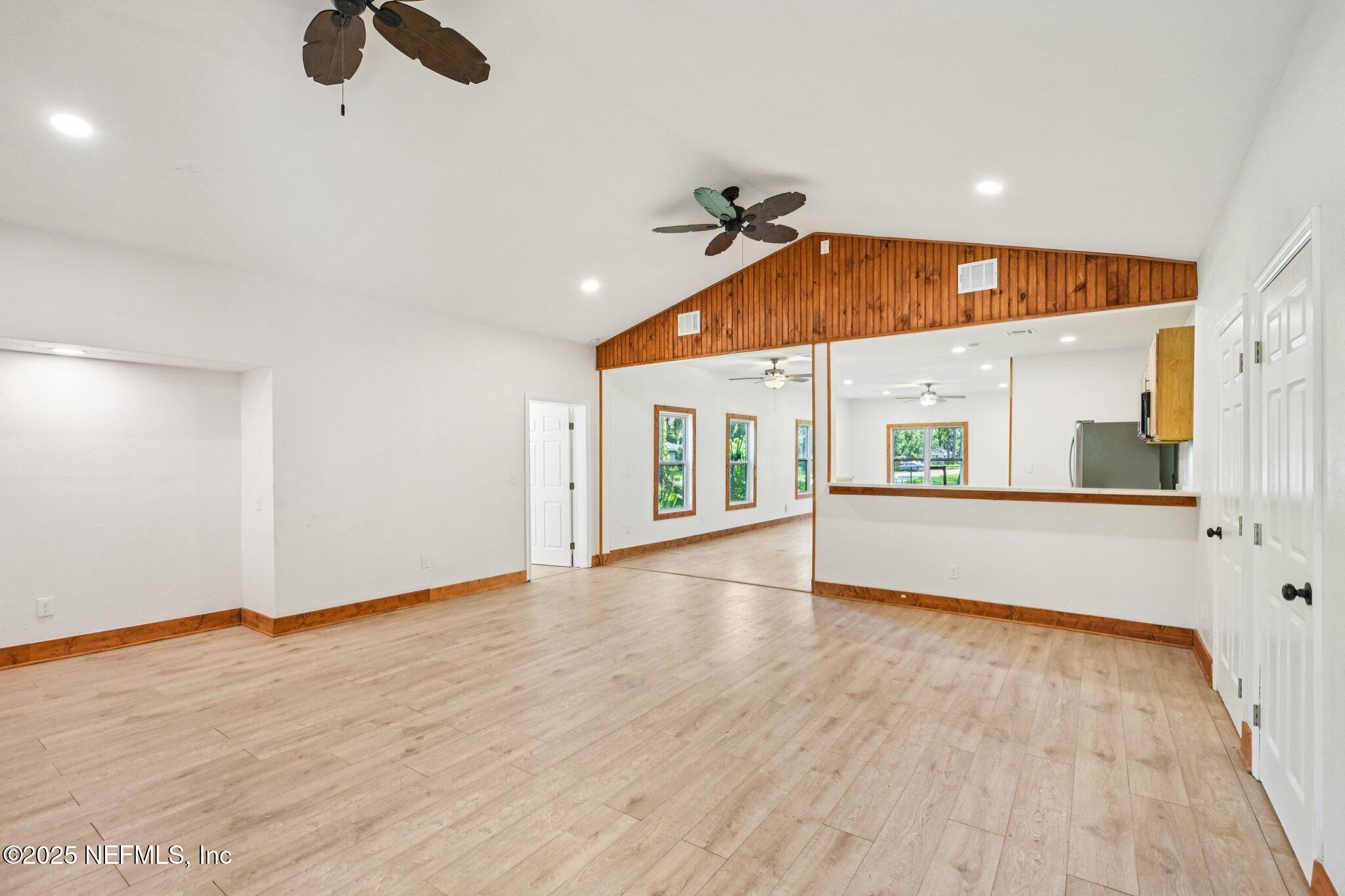 1217 Colley Road Starke, FL 32091 - Photo 11 of 42 an empty room with wooden floor fan and windows