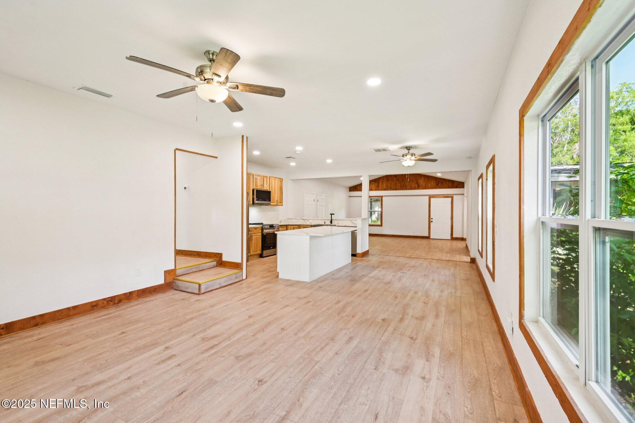 1217 Colley Road Starke, FL 32091 - Photo 12 of 42 a view of a kitchen with kitchen island wooden floor and a window