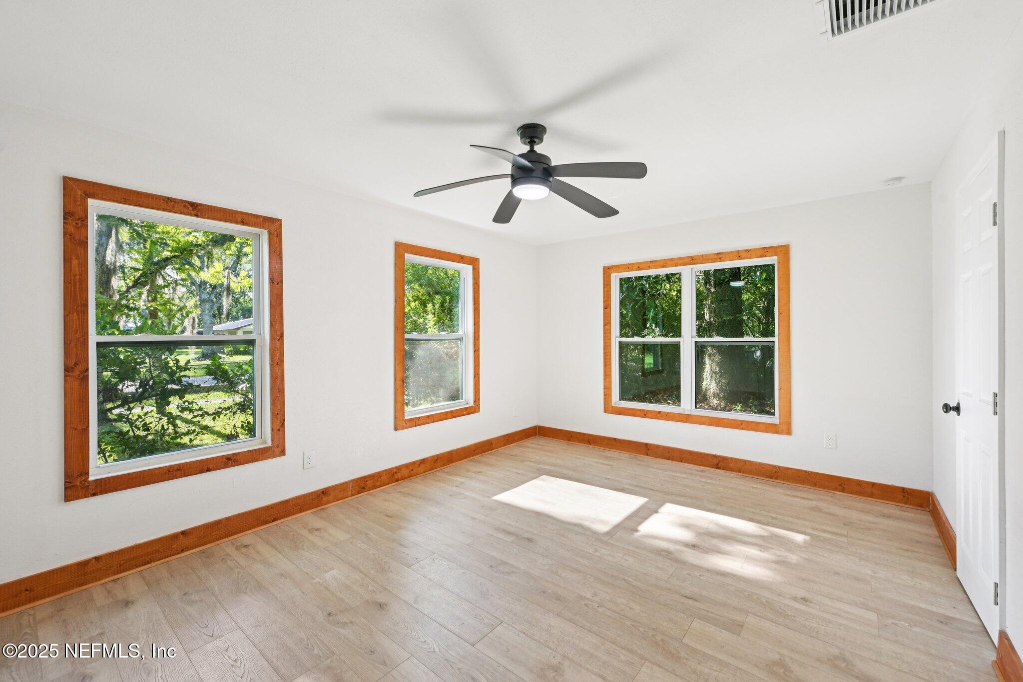 1217 Colley Road Starke, FL 32091 - Photo 16 of 42 a view of an empty room with a window and wooden floor