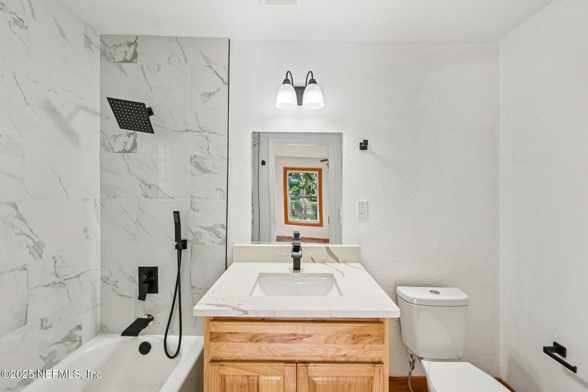 1217 Colley Road Starke, FL 32091 - Photo 19 of 42 a bathroom with a sink a toilet and a mirror