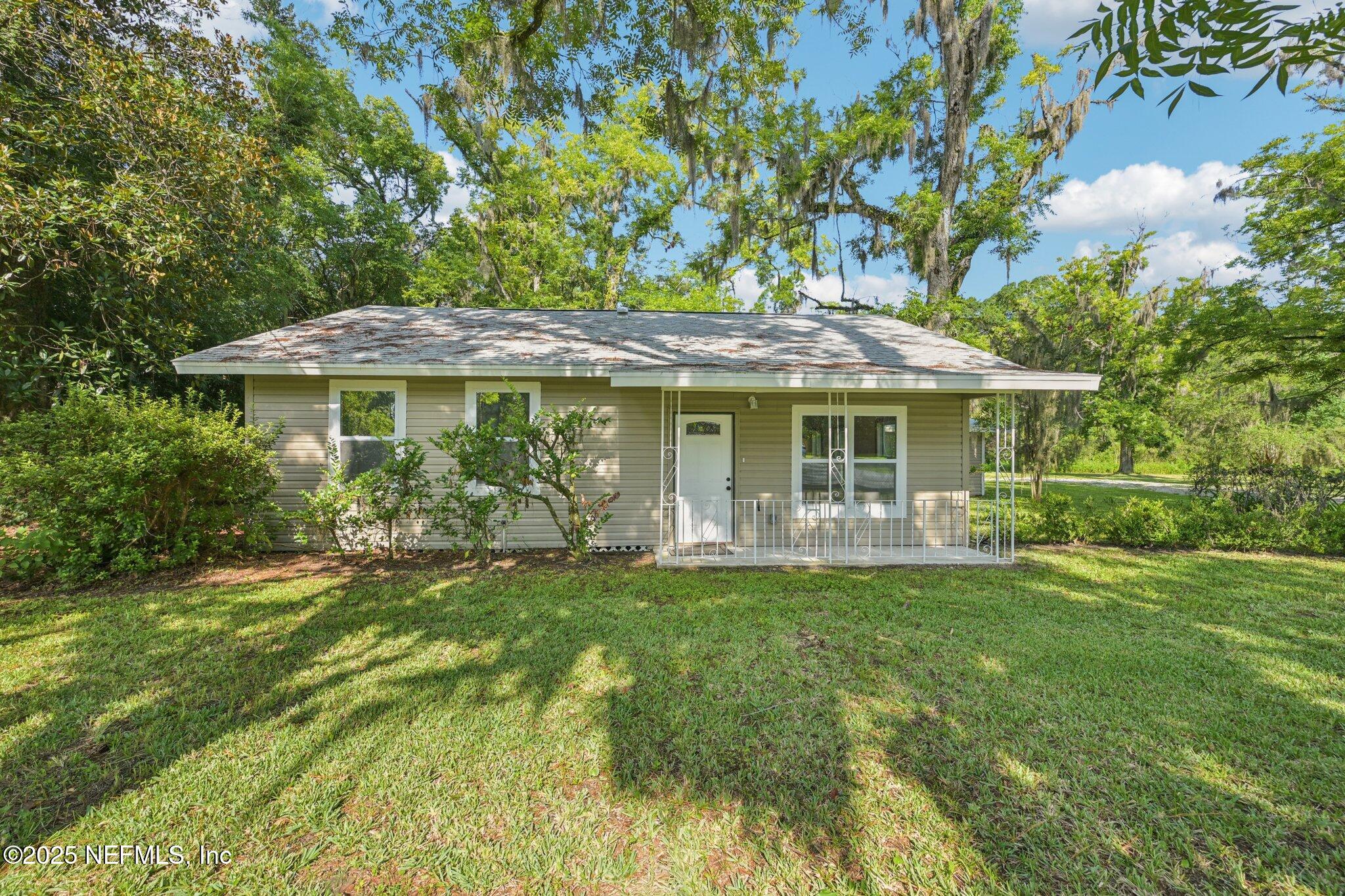 1217 Colley Road Starke, FL 32091 - Photo 2 of 42 a front view of a house with a garden