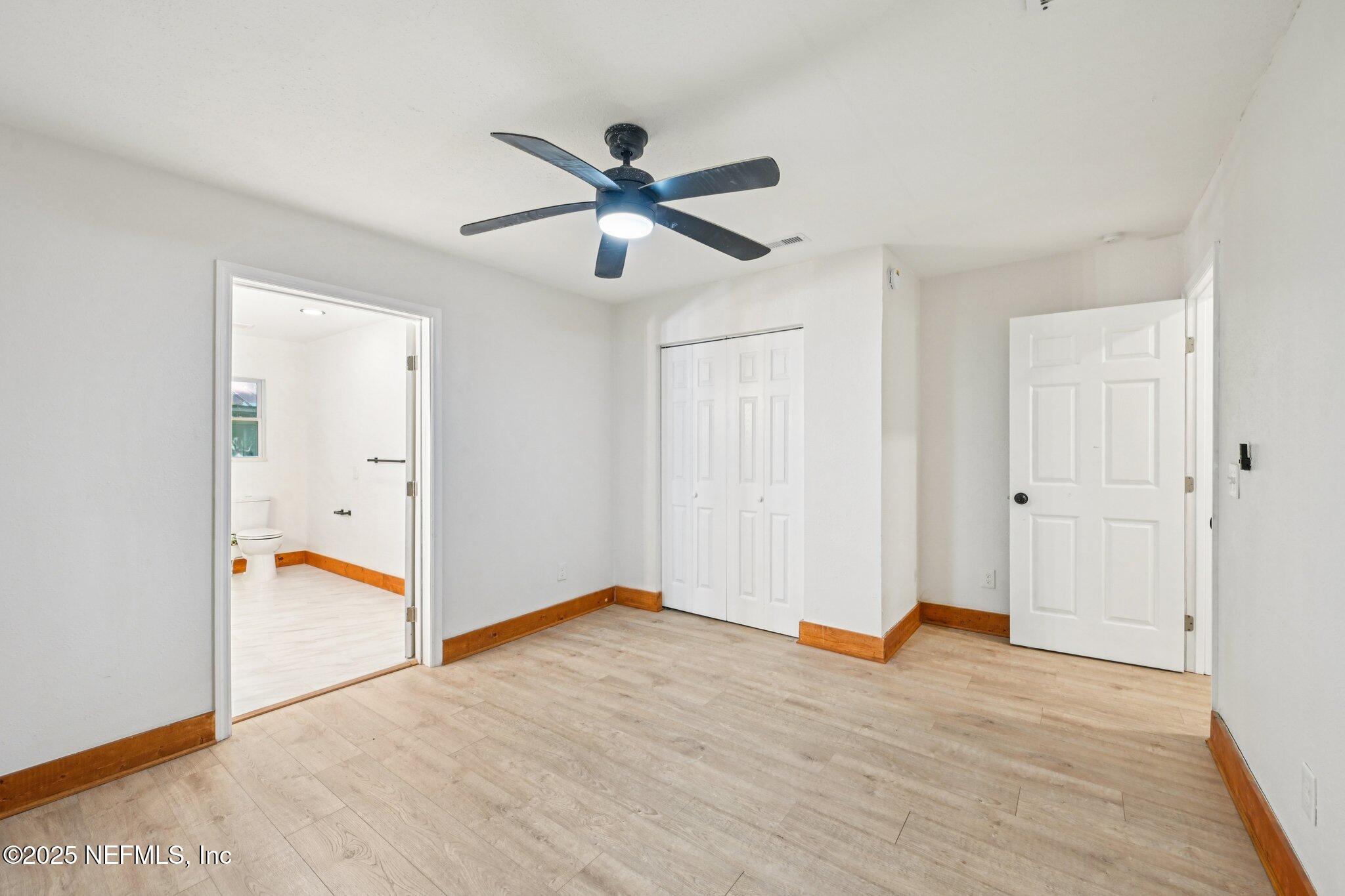 1217 Colley Road Starke, FL 32091 - Photo 22 of 42 an empty room with wooden floor and ceiling fan