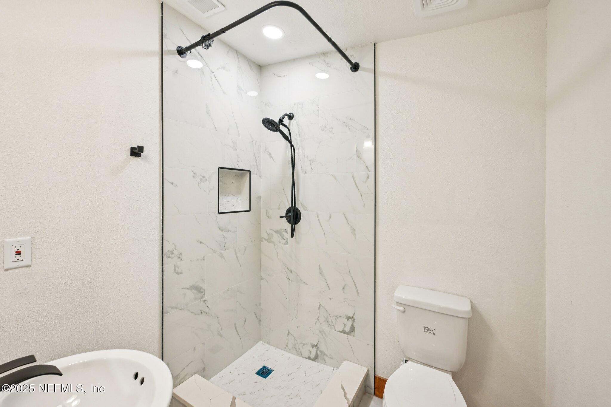 1217 Colley Road Starke, FL 32091 - Photo 30 of 42 a bathroom with a shower toilet and sink