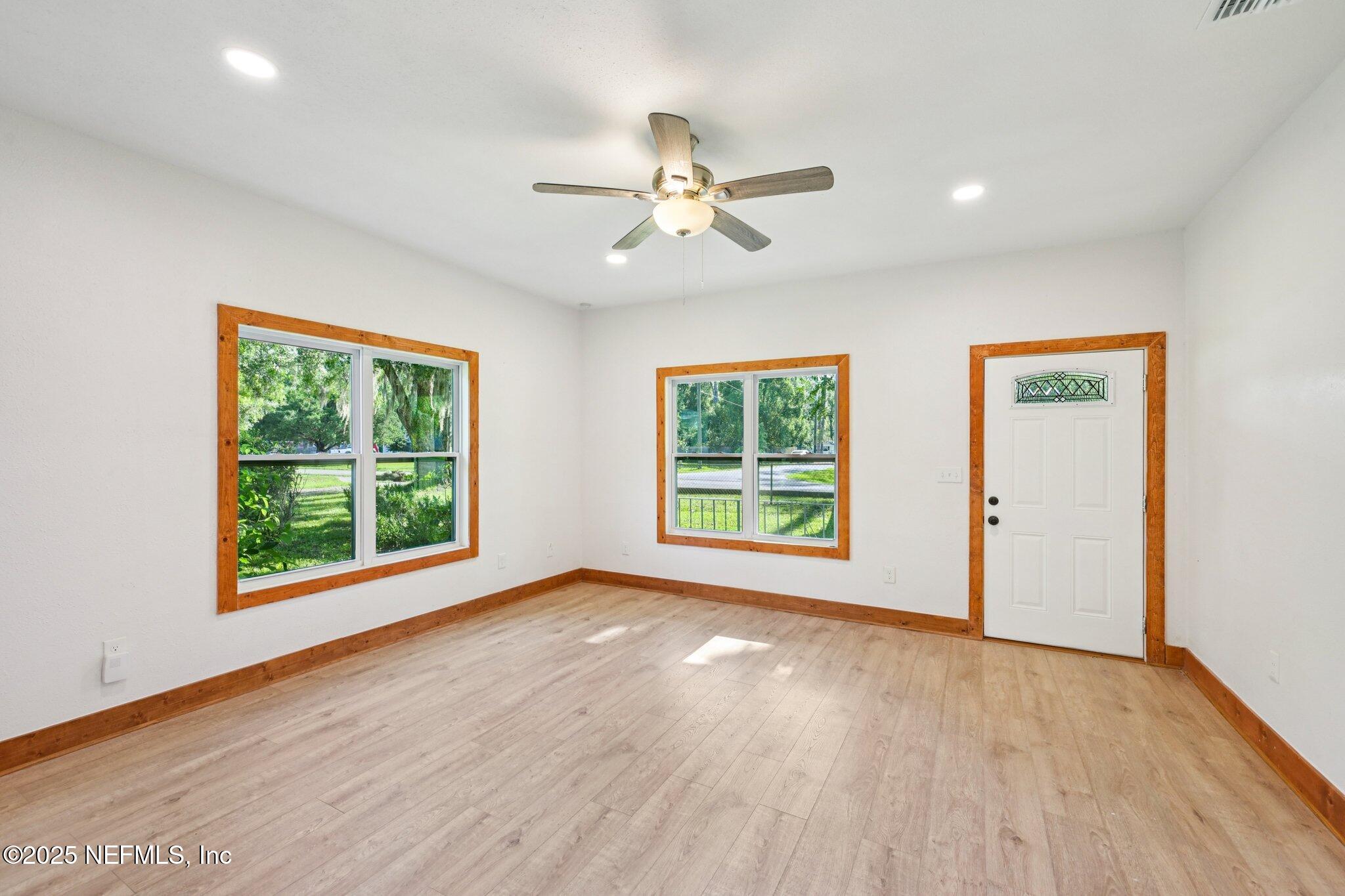 1217 Colley Road Starke, FL 32091 - Photo 6 of 42 a view of an empty room with a window and wooden floor