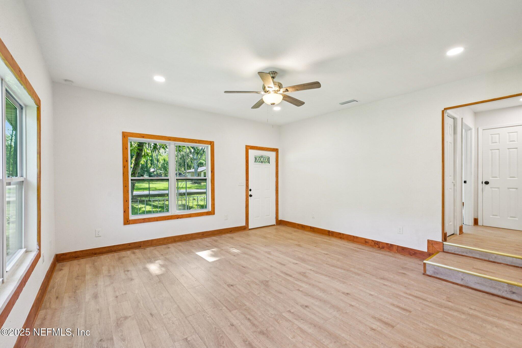 1217 Colley Road Starke, FL 32091 - Photo 7 of 42 an empty room with wooden floor and windows
