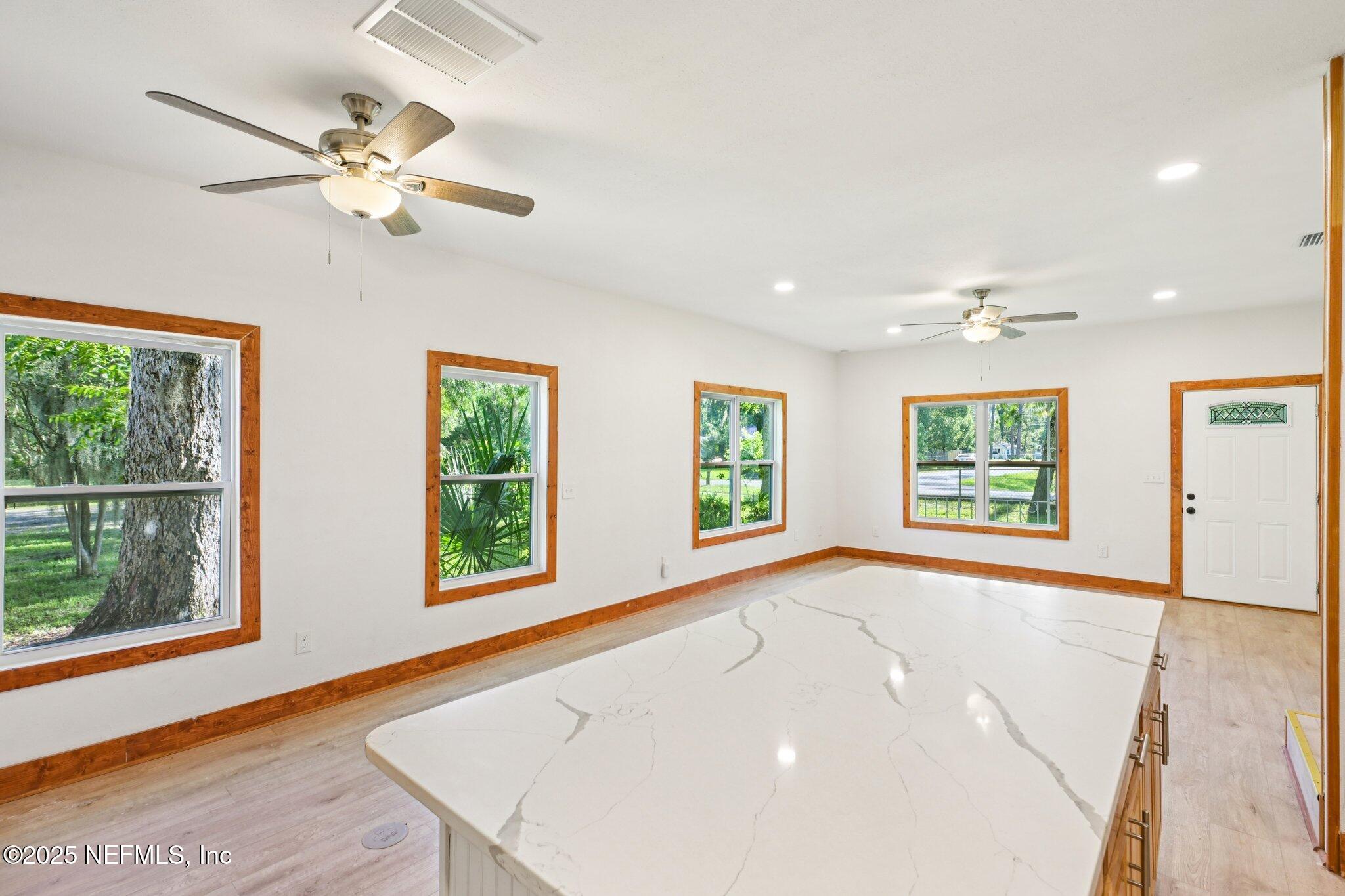 1217 Colley Road Starke, FL 32091 - Photo 8 of 42 a view of an empty room with wooden floor and a window