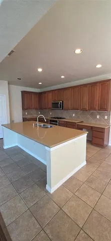 a view of kitchen with stainless steel appliances granite countertop a sink and a stove