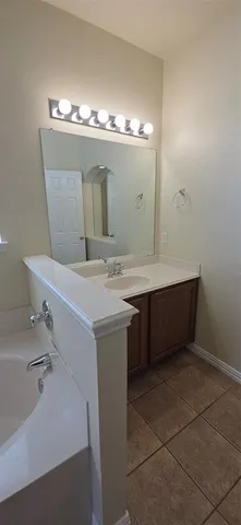 a bathroom with a sink vanity and mirror