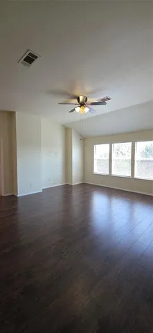 a view of wooden floor and windows in a room