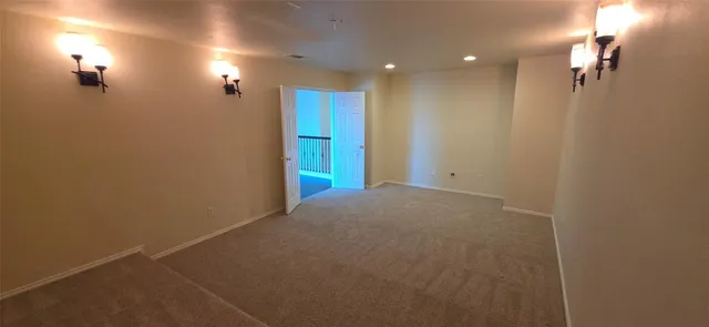 a view of a hallway with wooden floor and a window