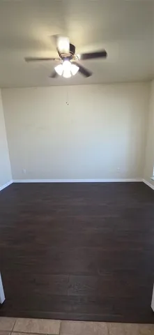 a view of a room with wooden floor