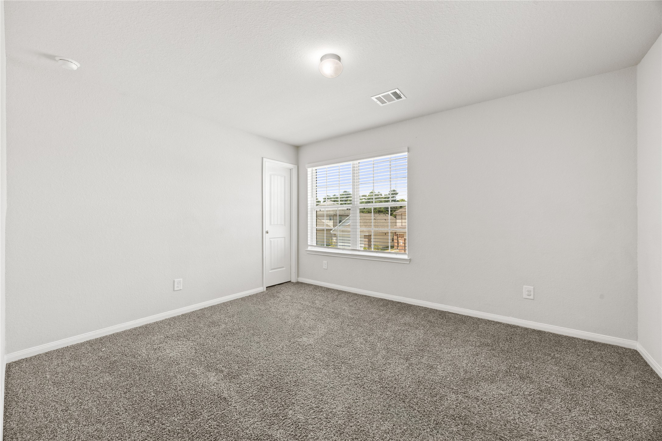 17514 Cuthbert Street Humble, TX 77346 - Photo 12 of 19 Bright, spacious bedroom with plush carpeting and a large window offering ample natural light.
