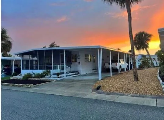 a front view of a house with garden and trees