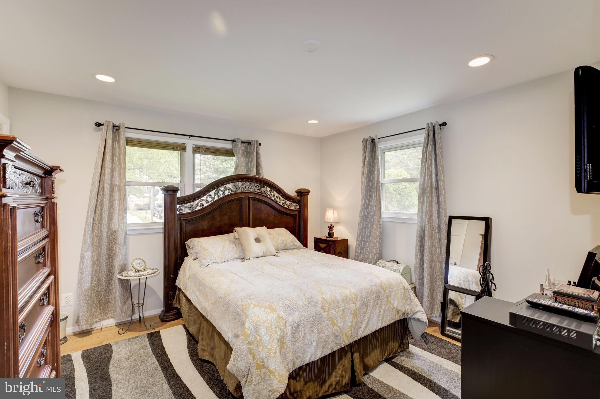 7909 Ellet Road Springfield, VA 22151 - Photo 15 of 30 a bedroom with a bed and a flat tv screen on the dresser