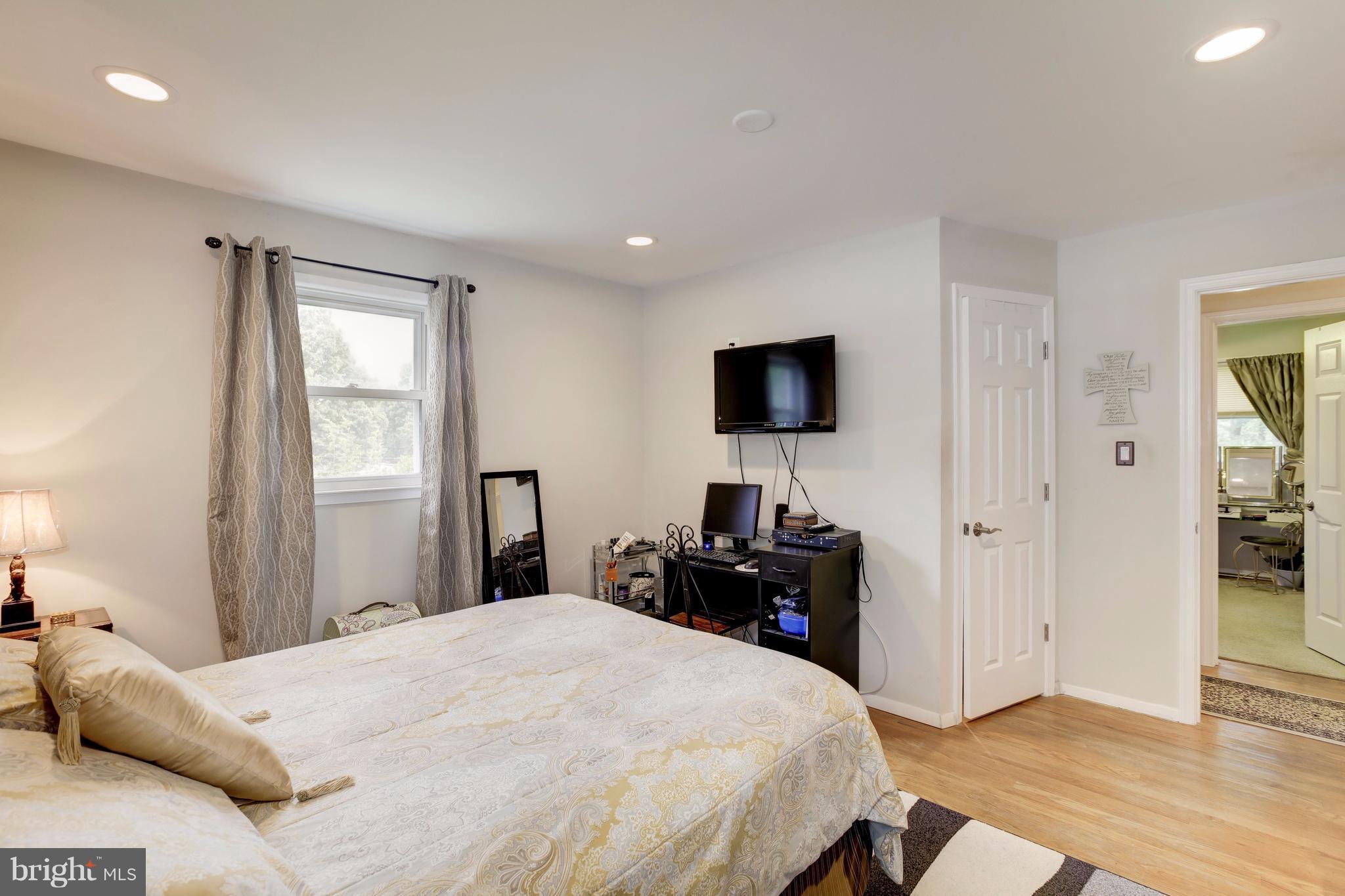 7909 Ellet Road Springfield, VA 22151 - Photo 16 of 30 a bedroom with a bed and a flat screen tv