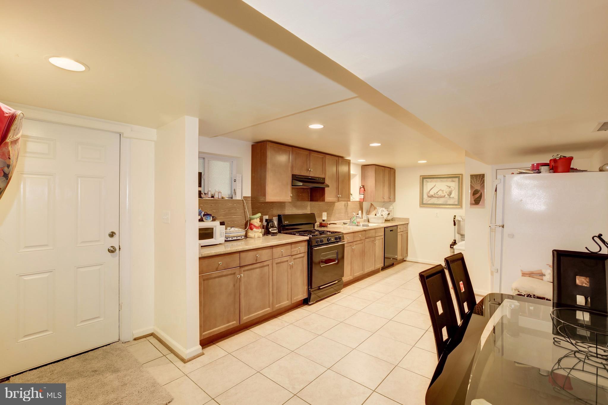 7909 Ellet Road Springfield, VA 22151 - Photo 24 of 30 a kitchen with cabinets a sink and a stove
