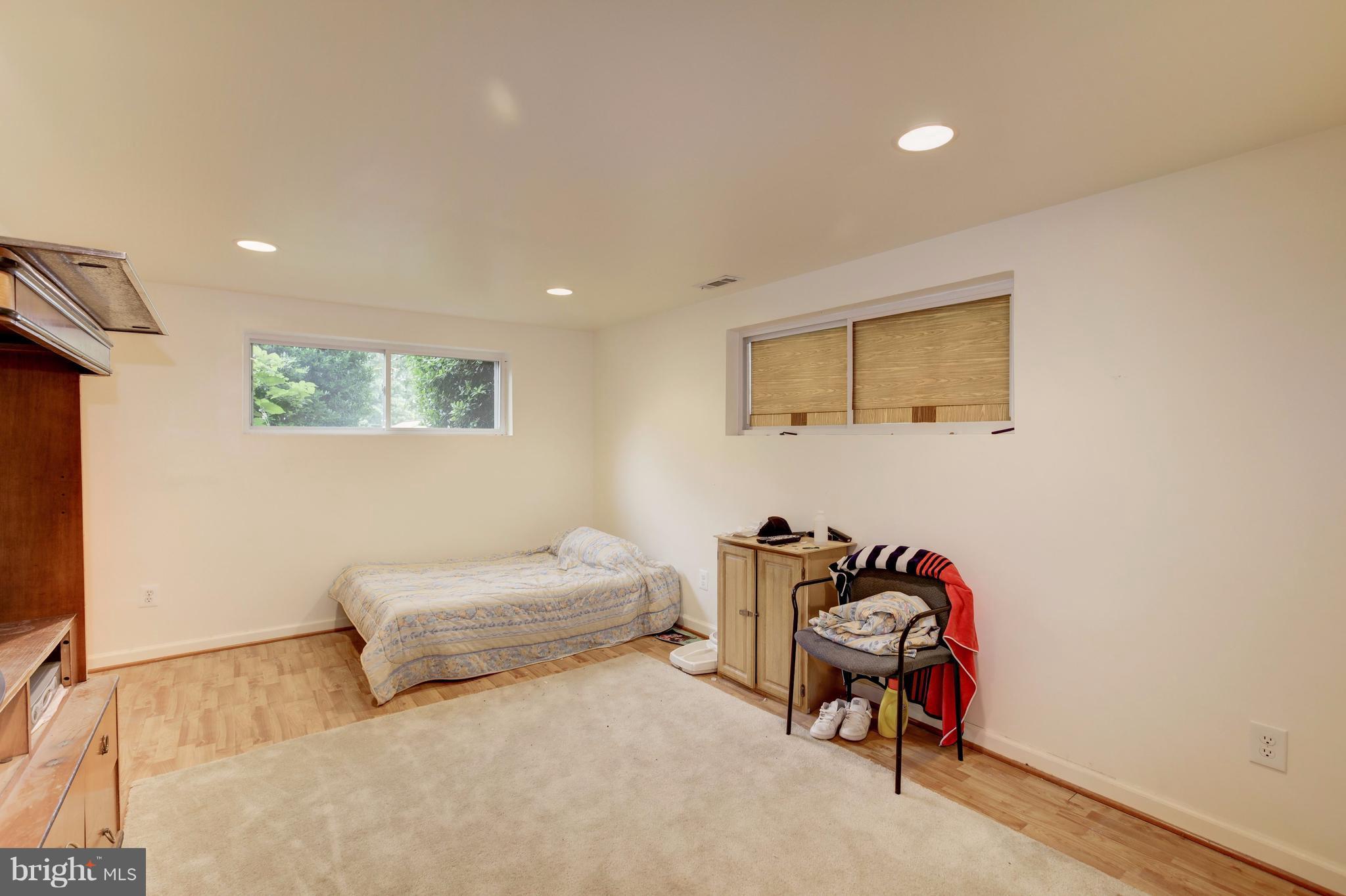 7909 Ellet Road Springfield, VA 22151 - Photo 26 of 30 a bedroom with furniture and a chandelier