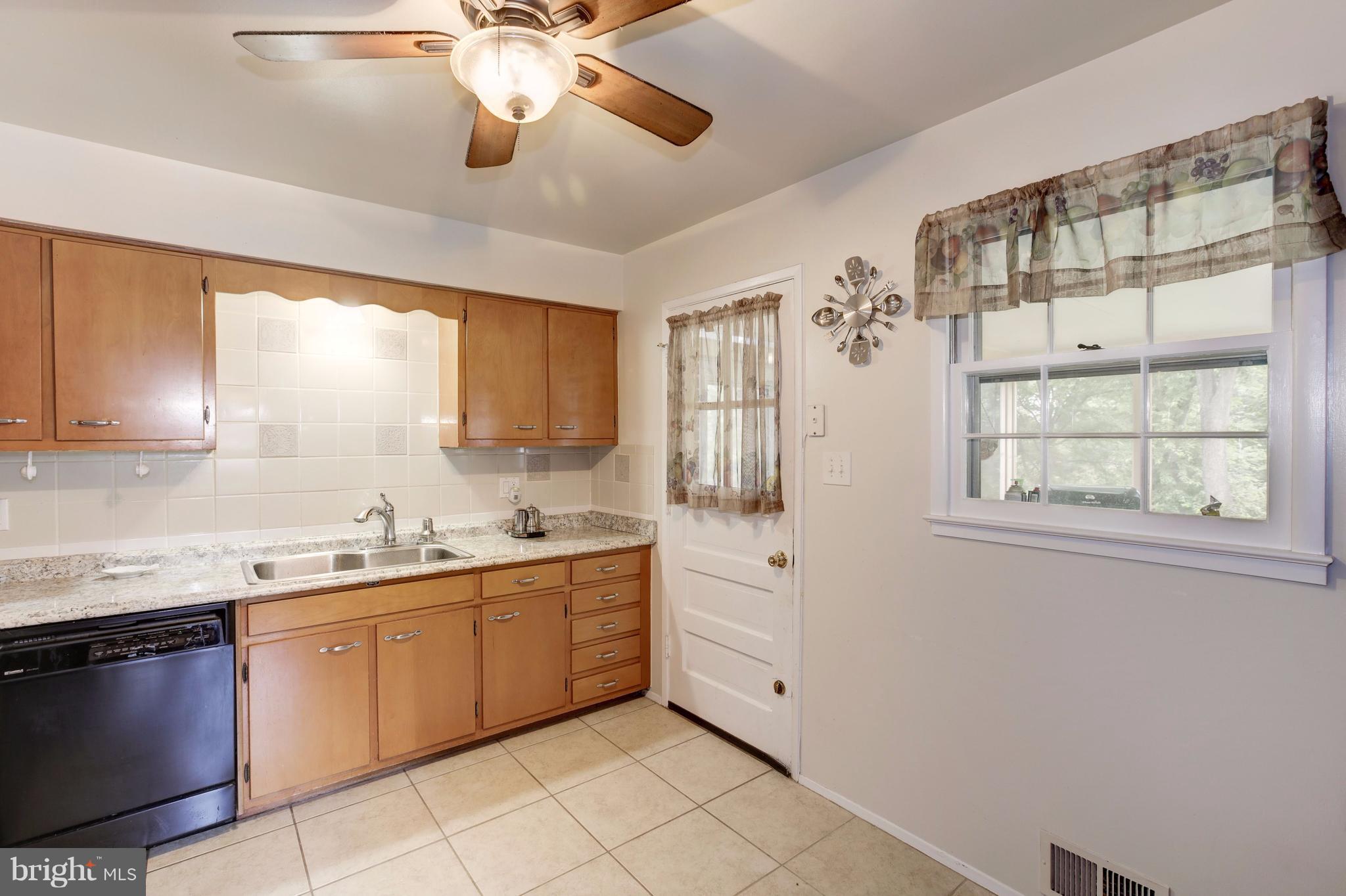 7909 Ellet Road Springfield, VA 22151 - Photo 6 of 30 a kitchen with a sink stove and cabinets