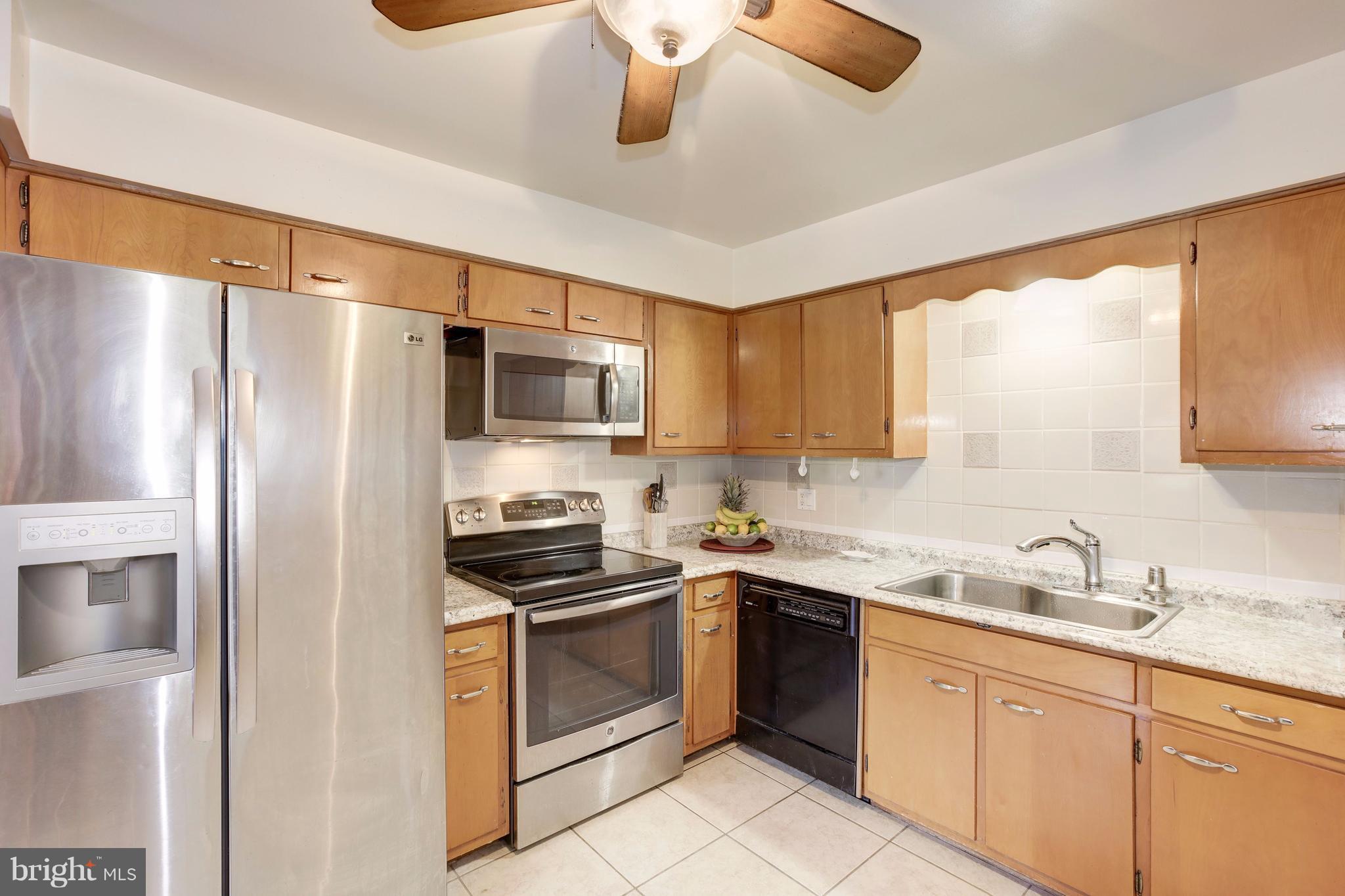 7909 Ellet Road Springfield, VA 22151 - Photo 7 of 30 a kitchen with stainless steel appliances a refrigerator sink and microwave