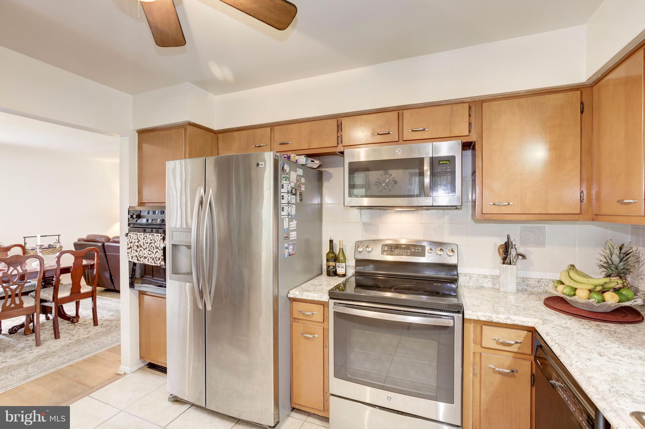 7909 Ellet Road Springfield, VA 22151 - Photo 8 of 30 a kitchen with stainless steel appliances granite countertop a refrigerator and a stove top oven