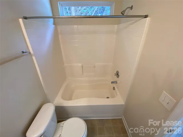 a bathroom with a toilet and shower