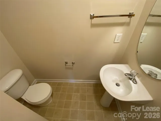 a bathroom with a sink mirror and toilet