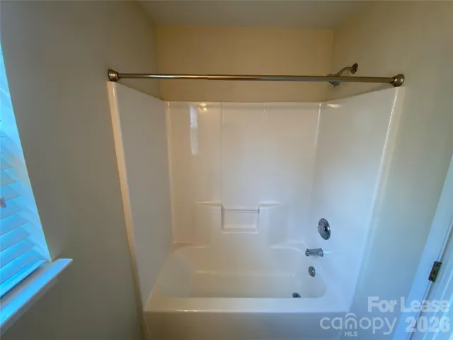 a bathroom with a shower and a bath tub