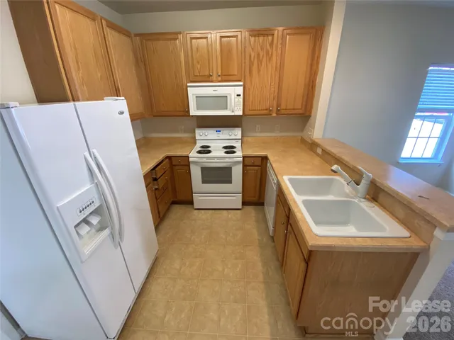 a kitchen with a sink a stove and a refrigerator