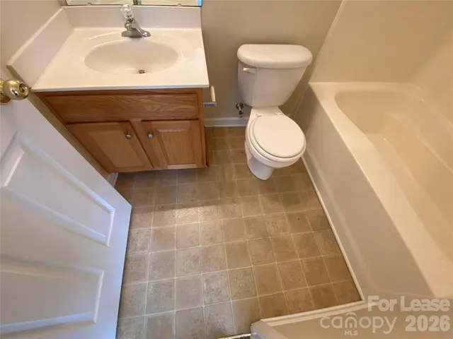 a bathroom with a sink a toilet and vanity