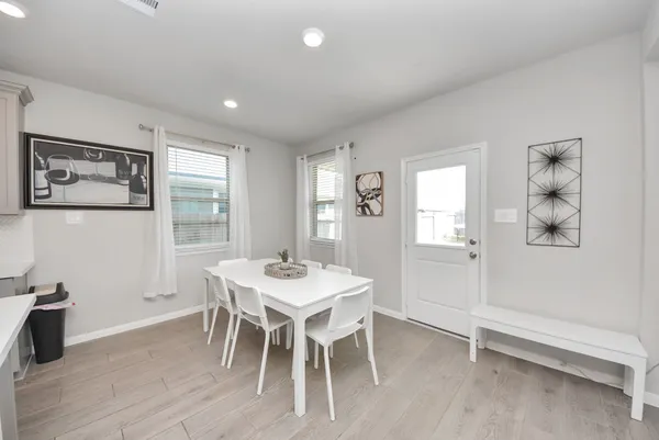 a kitchen with a table and chairs in it