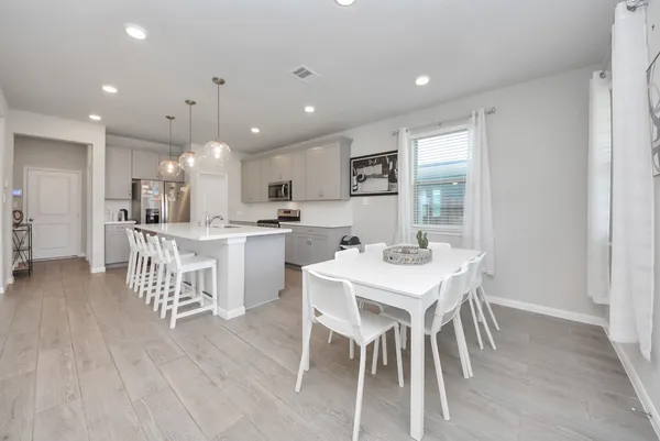 a large kitchen with a table and chairs